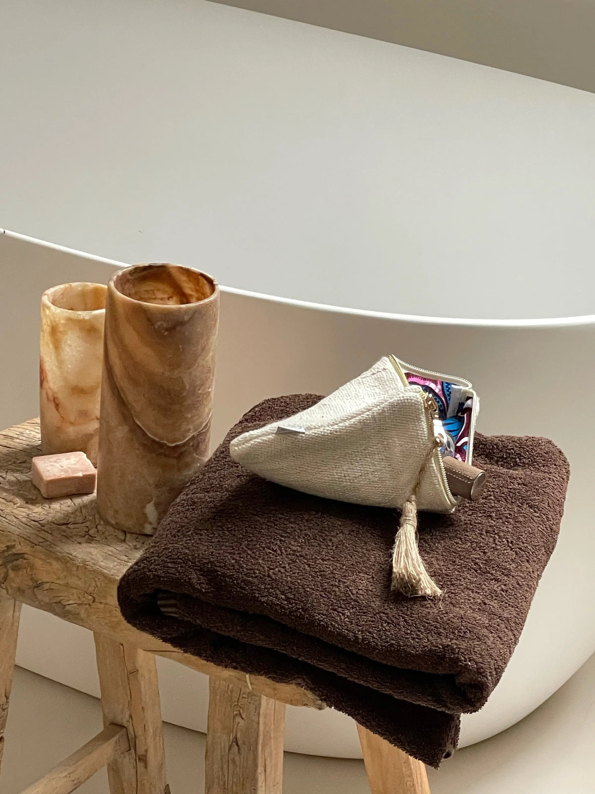Trousse ROHO-KIDO crème sur une serviette brune, près d’une baignoire