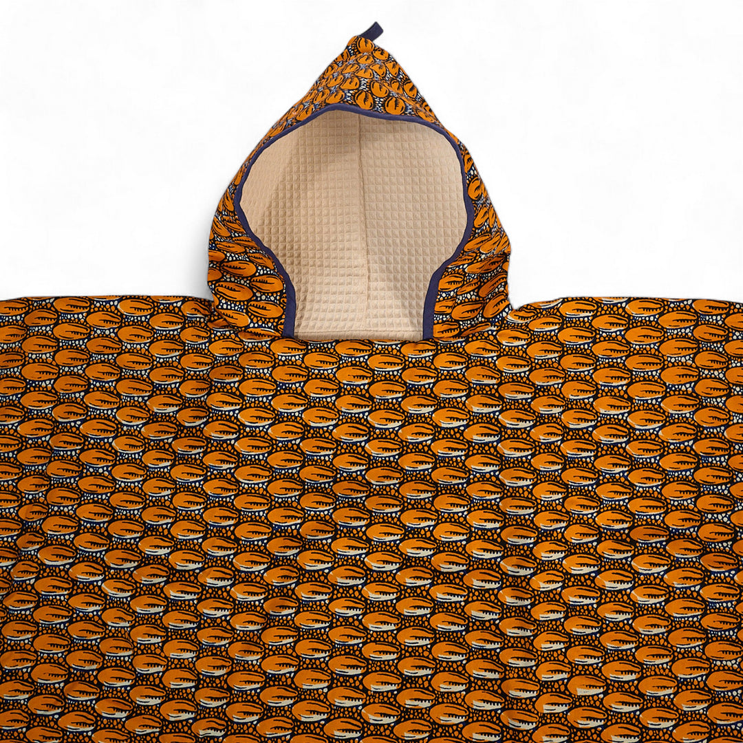 Trousse de toilette étanche ZAZA-CAURI en plastifié wax orange à motifs cauris, fermeture éclair noire sur le dessus.