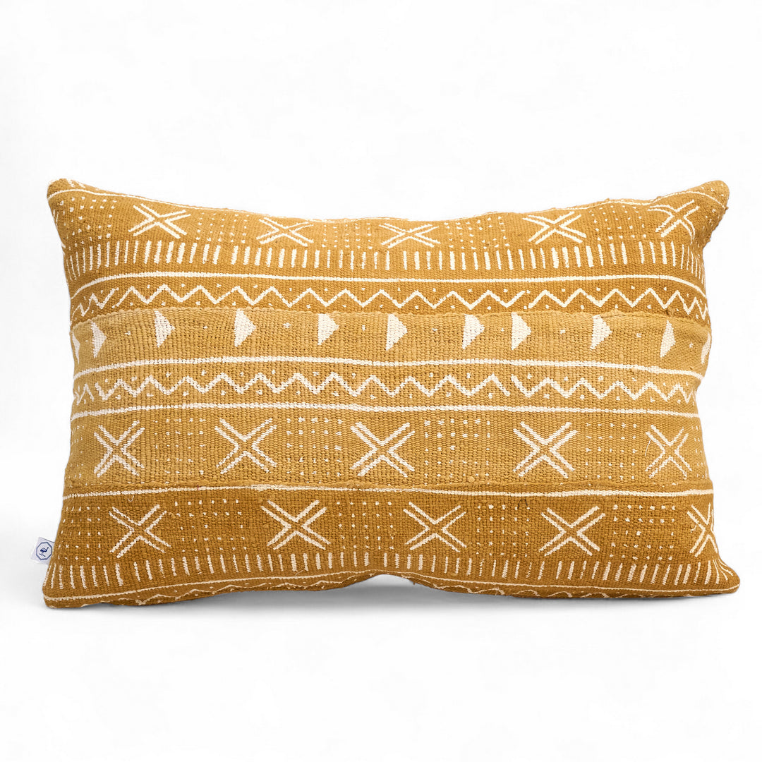 Housse de coussin ethnique KEUR 40 x 60 cm par Studio Matonge. Confectionné en Belgique à partir de tissu africain bogolan ocre à motifs blancs, tissés et teints à la main par des artisans de la région de Ségou.