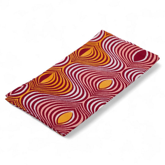 Flat-folded AYO napkin with red, orange and white waves